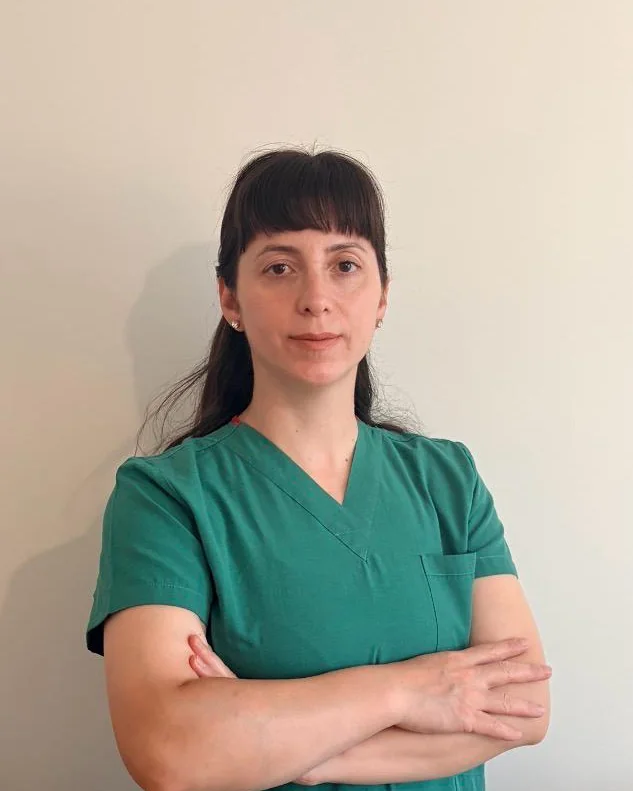 Evsen Taskum, Chartered Physiotherapist, wearing green clinical scrubs